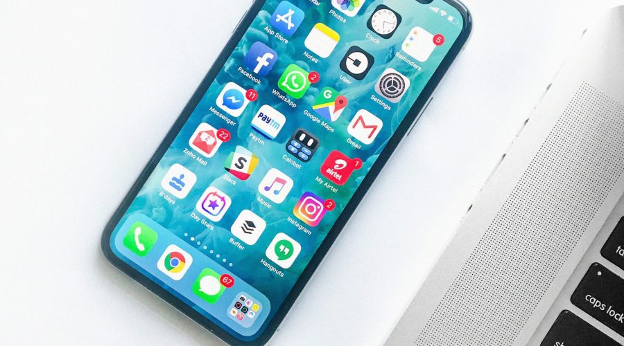 white smartphone near laptop
